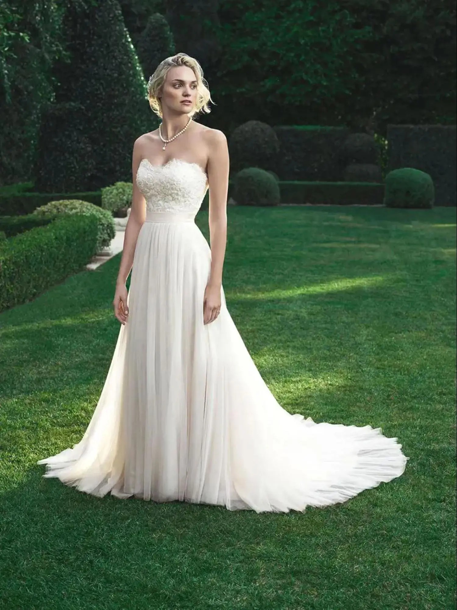 Model wearing strapless Casablanca style 2205 wedding dress
