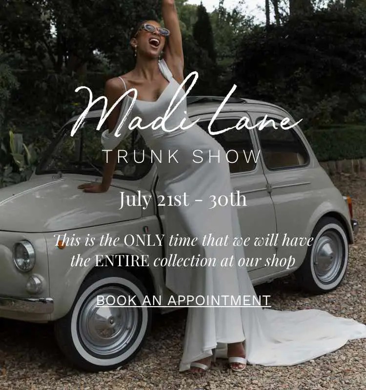 Madi Lane trunk show at Dublin Bridal. Model wearing Madi Lane wedding dresses leaning against vintage car.